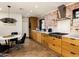 Modern kitchen with custom wood cabinetry, stainless steel appliances, and an exposed brick accent wall at 5807 N 18Th St, Phoenix, AZ 85016