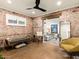 Stylish living room with exposed brick, modern decor, and a view to another living area at 5807 N 18Th St, Phoenix, AZ 85016