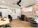 Contemporary office featuring a unique ceiling fan and exposed brick accent wall at 5807 N 18Th St, Phoenix, AZ 85016