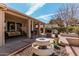 Inviting back patio with comfortable seating, a water fountain feature, and a built-in barbecue area at 5902 S Amberwood Dr, Sun Lakes, AZ 85248