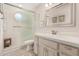 Bathroom featuring walk-in shower with glass door, ample vanity space, and neutral tile at 5902 S Amberwood Dr, Sun Lakes, AZ 85248