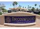 Elegant sign for Ironwood Country Club set against a backdrop of palm trees and golf carts at 5902 S Amberwood Dr, Sun Lakes, AZ 85248