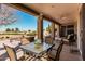 Relaxing covered patio with comfortable seating, a ceiling fan, and views of the surrounding landscape at 5902 S Amberwood Dr, Sun Lakes, AZ 85248