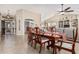 Elegant formal dining area with a large table, seating for six, and an open view into the living room and kitchen at 5902 S Amberwood Dr, Sun Lakes, AZ 85248