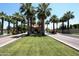 Well manicured entrance lined with palm trees leading to the community clubhouse at 5902 S Amberwood Dr, Sun Lakes, AZ 85248