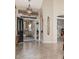 Welcoming foyer featuring tiled flooring, decorative lighting, and a view of the formal dining area at 5902 S Amberwood Dr, Sun Lakes, AZ 85248