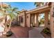 Inviting front entrance with a charming courtyard, brick paving, and decorative sun accent at 5902 S Amberwood Dr, Sun Lakes, AZ 85248