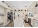 Well-lit kitchen featuring stainless steel appliances, light wood cabinetry, an island, and a breakfast bar at 5902 S Amberwood Dr, Sun Lakes, AZ 85248