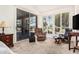 Cozy sitting area with recliner seating, natural light from windows and doors overlooking the outdoor space at 5902 S Amberwood Dr, Sun Lakes, AZ 85248