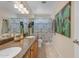 Bathroom featuring a double sink vanity, large mirror, and a cactus painting at 5940 E Taunus Cir, Mesa, AZ 85215