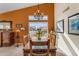 Dining room with contemporary chandelier and bright orange accent wall at 5940 E Taunus Cir, Mesa, AZ 85215