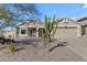 Charming single-story home with desert landscaping and two-car garage at 5940 E Taunus Cir, Mesa, AZ 85215