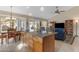 Open-concept kitchen flowing into the living area with a view of the backyard at 5940 E Taunus Cir, Mesa, AZ 85215