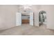 Neutral bedroom features high ceilings, a ceiling fan, a bathroom, a closet, and neutral-colored walls and carpet at 609 E Mesquite Cir # D131, Tempe, AZ 85288