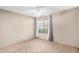 Neutral bedroom featuring a window with curtains, a ceiling fan, and neutral-colored walls and carpet at 609 E Mesquite Cir # D131, Tempe, AZ 85288