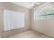 Neutral bedroom with vaulted ceilings and window with white blinds at 609 E Mesquite Cir # D131, Tempe, AZ 85288