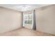 Neutral bedroom featuring a window with curtains, a ceiling fan, and neutral-colored walls and carpet at 609 E Mesquite Cir # D131, Tempe, AZ 85288