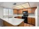 Functional kitchen with stainless appliances, ample counter space, and oak cabinetry at 609 E Mesquite Cir # D131, Tempe, AZ 85288