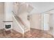 Open living room with Saltillo tile flooring, fireplace, and staircase at 609 E Mesquite Cir # D131, Tempe, AZ 85288