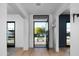 Bright and airy foyer with hardwood floors, stylish light fixtures, and a view of the front yard at 6312 E Calle Del Paisano --, Scottsdale, AZ 85251