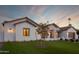 Exterior view showcasing a desert landscaped yard, modern white exterior, and warm lighting at 6312 E Calle Del Paisano --, Scottsdale, AZ 85251