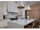 Beautiful kitchen featuring a large island, white cabinets, and a decorative tile backsplash at 6312 E Calle Del Paisano --, Scottsdale, AZ 85251