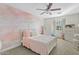 Light-filled bedroom featuring a painted pink wall, a cozy white bed, and ample natural light from the window at 6440 E Jean Dr, Scottsdale, AZ 85254