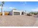 Modern home with a brick driveway, two-car garage, and desert landscaping at 6440 E Jean Dr, Scottsdale, AZ 85254