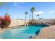 Inviting backyard pool featuring a rock waterfall, lush greenery, and comfortable patio seating at 6440 E Jean Dr, Scottsdale, AZ 85254