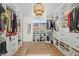 Well-organized walk-in closet with ample storage, custom shelving, and a central seating area at 6440 E Jean Dr, Scottsdale, AZ 85254