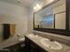 This bathroom boasts double sinks, a large mirror and coordinated fixtures at 650 N Hawes Rd # 3827, Mesa, AZ 85207