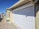 Side view of the home showing covered carport with roll-up doors for secure parking at 650 N Hawes Rd # 3827, Mesa, AZ 85207