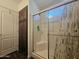 Tiled shower features glass doors and a built-in seat at 650 N Hawes Rd # 3827, Mesa, AZ 85207