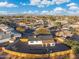 An aerial view shows a fenced yard of home near a neighborhood in a sunny suburban area at 6601 E Latham St, Scottsdale, AZ 85257