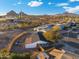 Aerial view of cozy home with fenced backyard and mountain views in the distance at 6601 E Latham St, Scottsdale, AZ 85257