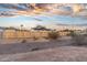 Newly fenced backyard features a wooden fence, and desert landscaping for water conservation at 6601 E Latham St, Scottsdale, AZ 85257