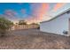 Backyard exterior view with gravel ground and a newly installed wooden fence at 6601 E Latham St, Scottsdale, AZ 85257