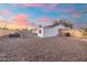 Gravel backyard with a built-in grill and a wooden fence, perfect for outdoor entertaining at 6601 E Latham St, Scottsdale, AZ 85257