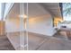 Covered carport with a paved area with chairs and a table next to a white brick exterior at 6601 E Latham St, Scottsdale, AZ 85257