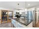 Open kitchen with white cabinets, granite counters, stainless appliances, and a view to the back yard at 6601 E Latham St, Scottsdale, AZ 85257