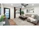 Bright living room with modern furniture, wood floors, and a view of the front yard at 6601 E Latham St, Scottsdale, AZ 85257