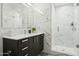 Modern bathroom features a large shower with glass doors and a dark vanity with a white countertop at 7120 E Kierland Blvd # 601, Scottsdale, AZ 85254