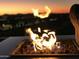 Cozy fire pit with flames in a modern outdoor setting against an evening backdrop at 7120 E Kierland Blvd # 601, Scottsdale, AZ 85254