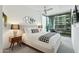 Serene main bedroom featuring large windows, a ceiling fan, and modern decor at 7120 E Kierland Blvd # 601, Scottsdale, AZ 85254