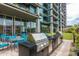 Well-equipped outdoor kitchen and dining area is surrounded by lush greenery at 7120 E Kierland Blvd # 601, Scottsdale, AZ 85254