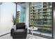 Cozy sitting area with an armchair, side table, and views of the neighborhood through large windows at 7120 E Kierland Blvd # 601, Scottsdale, AZ 85254