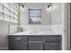 Bathroom with grey cabinets, tile countertops, and ample natural light at 713 E Eason Ave, Buckeye, AZ 85326