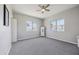 Carpeted bedroom featuring large windows and neutral paint at 713 E Eason Ave, Buckeye, AZ 85326