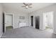 Spacious bedroom with gray carpet, ceiling fan, and neutral paint at 713 E Eason Ave, Buckeye, AZ 85326