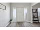 Inviting foyer with light walls, wood-look flooring, and stylish decor at 713 E Eason Ave, Buckeye, AZ 85326